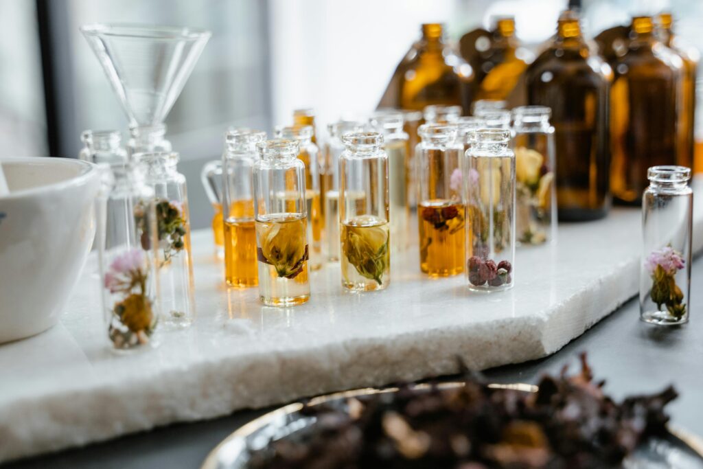 pexels-photo-8450508-8450508 Close-up of various aromatic floral oils in glass bottles, showcasing their vibrant colors and natural ingredients.